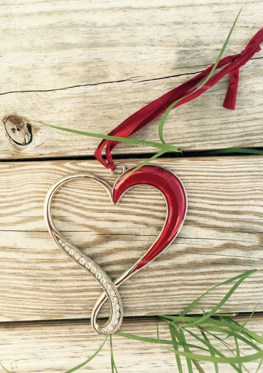 Heart outdoors . A metal heart on a wooden pier 