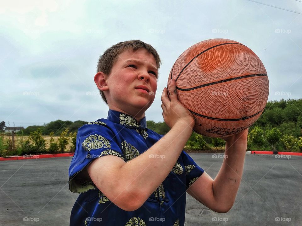 Boy Shooting Basketball
