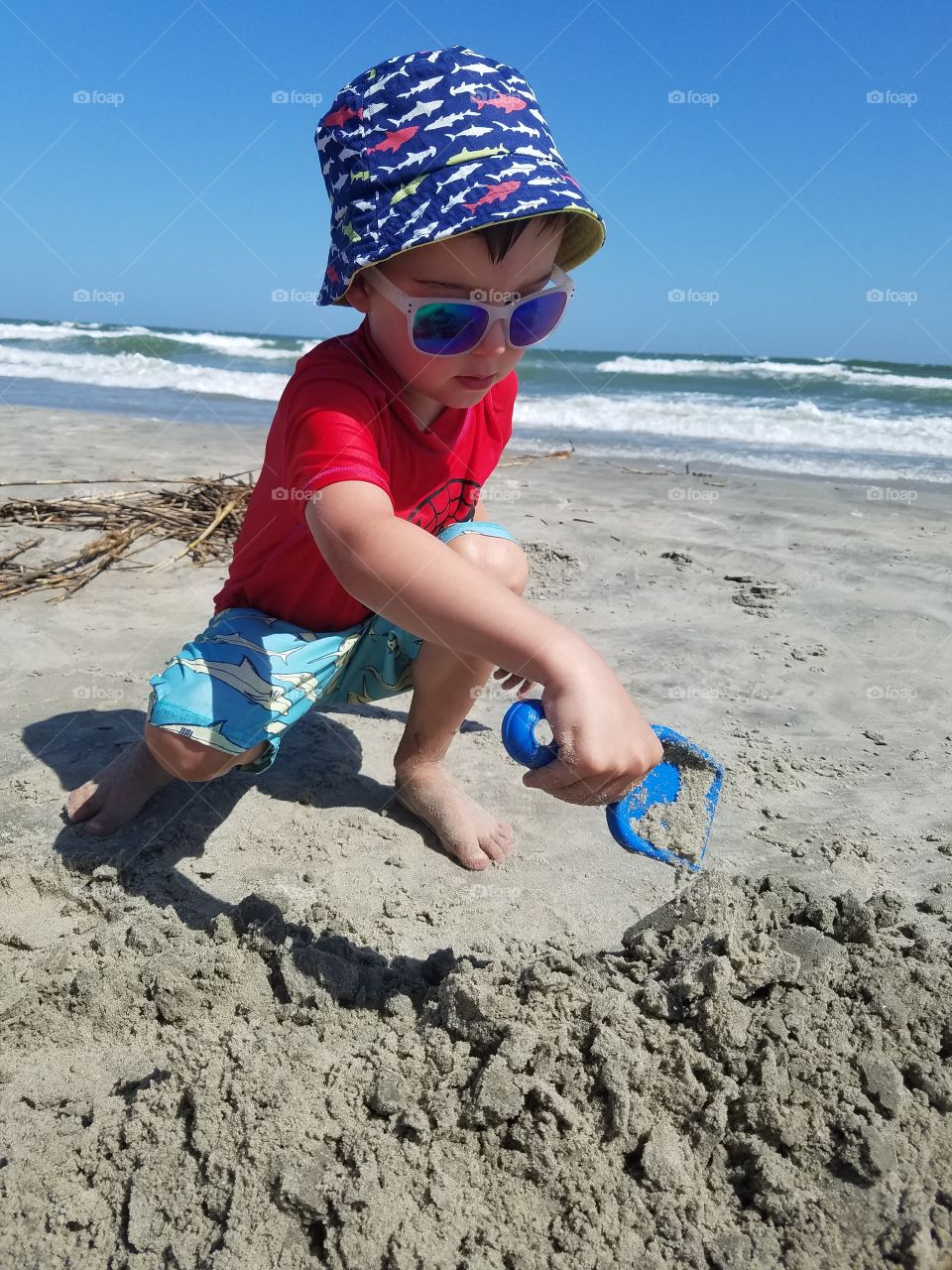 Child shoveling sand