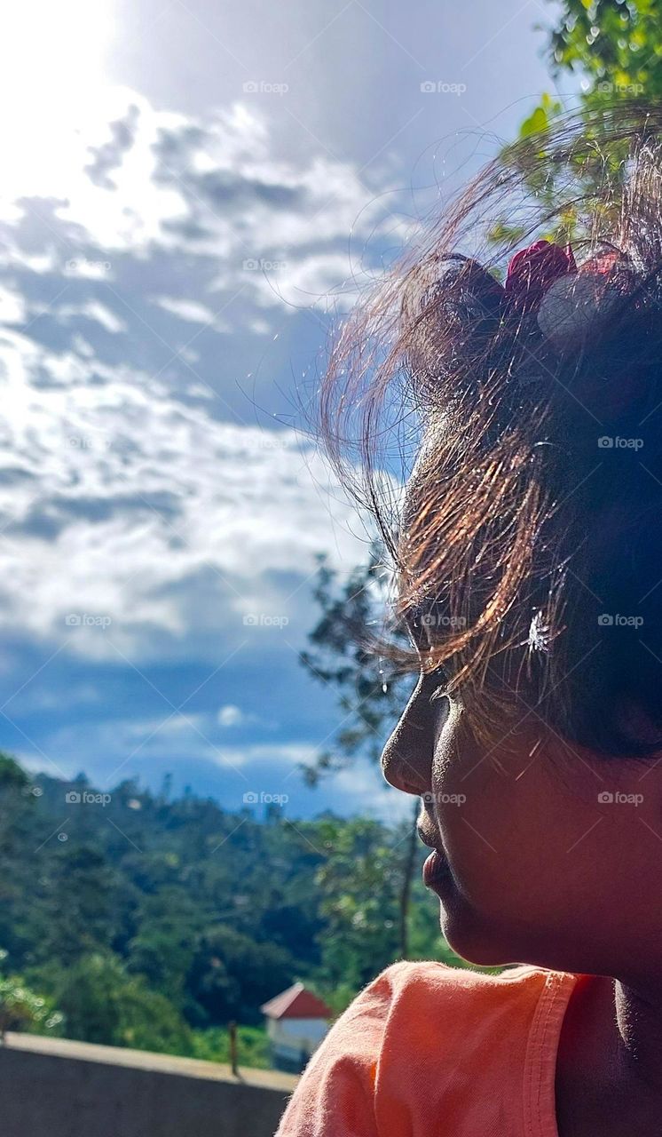 A kid girl in sunny background