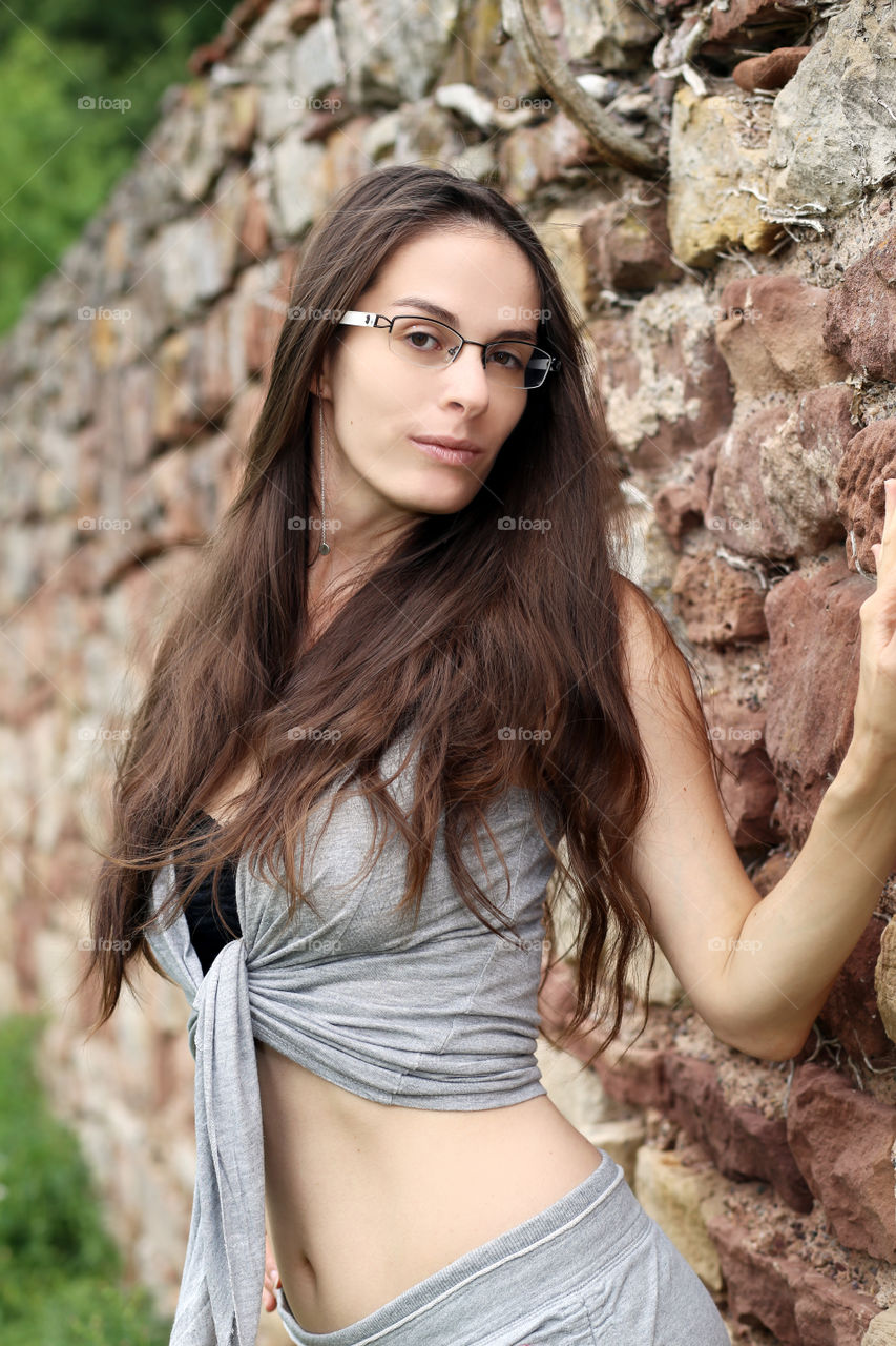 Sexy French girl against a stone wall