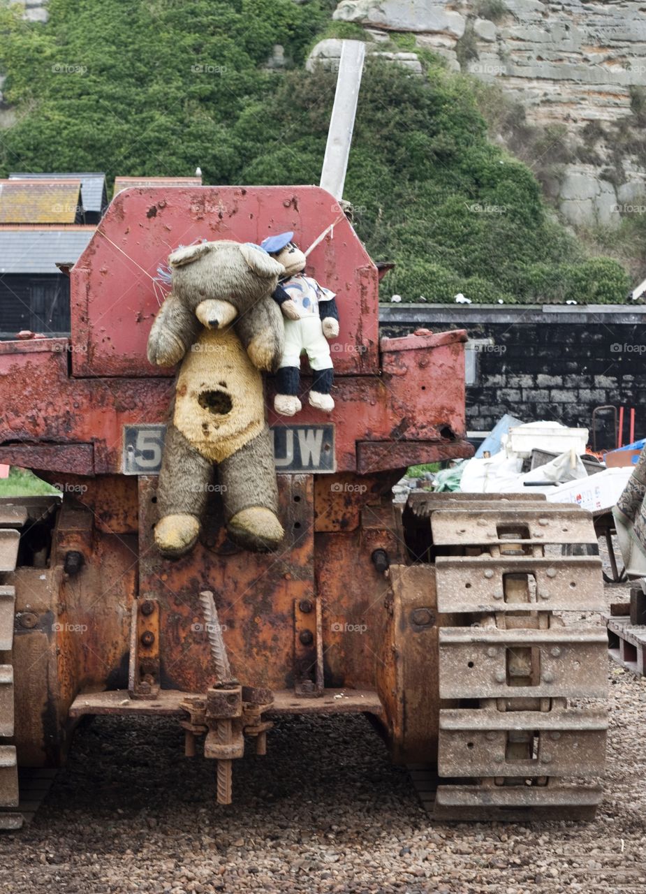 Tired looking mascots hang from a fishing tractor on Hastings fisherman’s beach