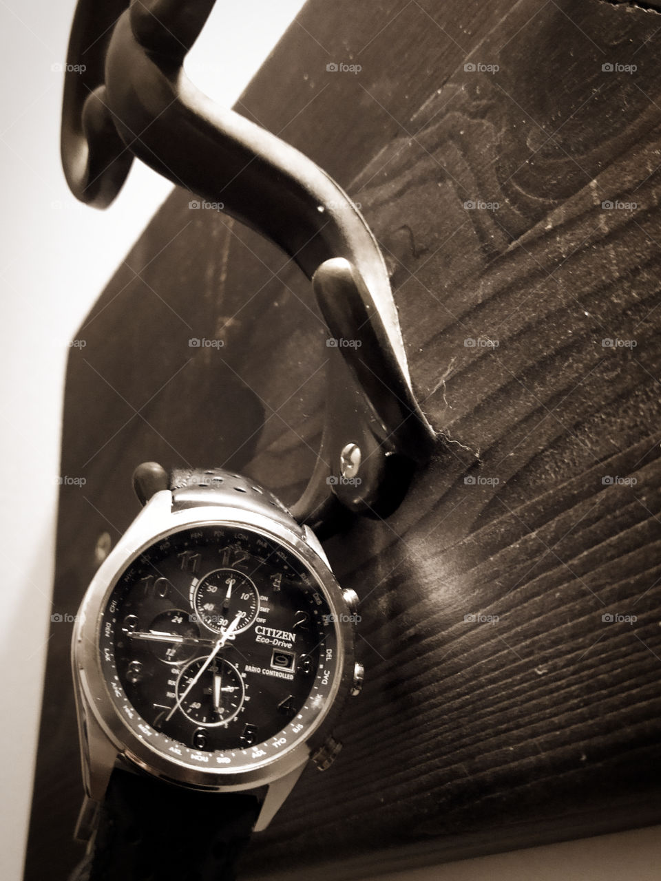 Men's wristwatch on an old hook