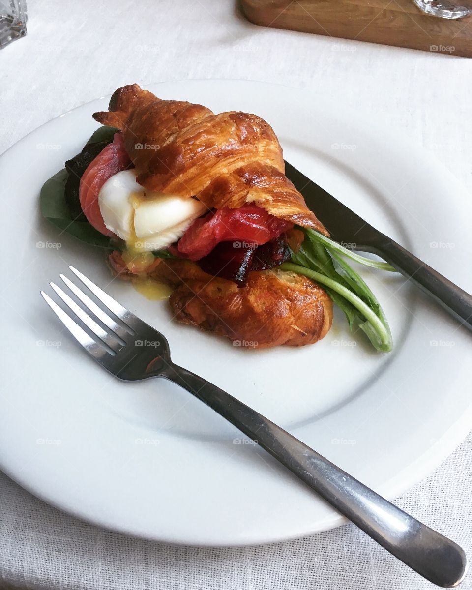 Croissant with salmon and poached egg