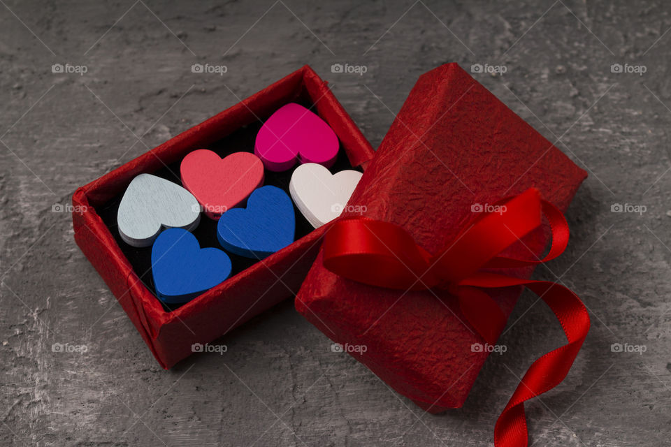 red gift box on a concrete background.  Christmas presents concept