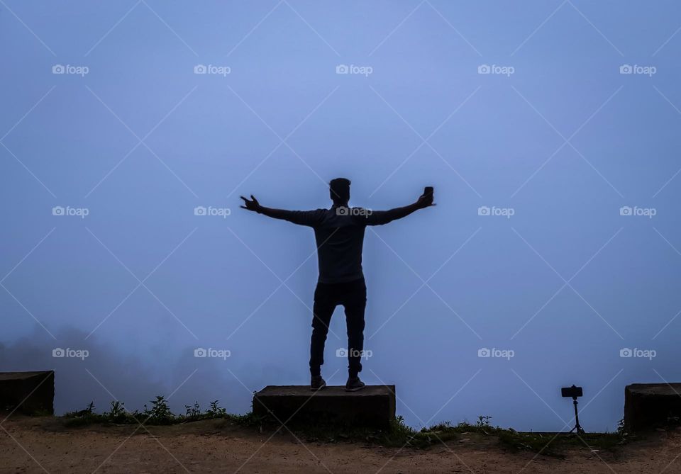 a man standing in front of fog