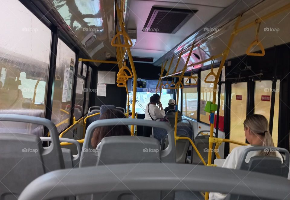 seated passengers on a bus.