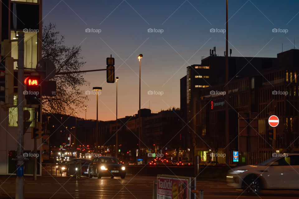 crossing with cars and traffic light in the dusk