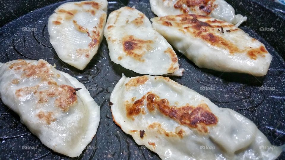 Jiaozi (Chinese) or gyoza (Japanese). Pan-fried variety that is very popular in China and Japan. Also commonly called dumpling.