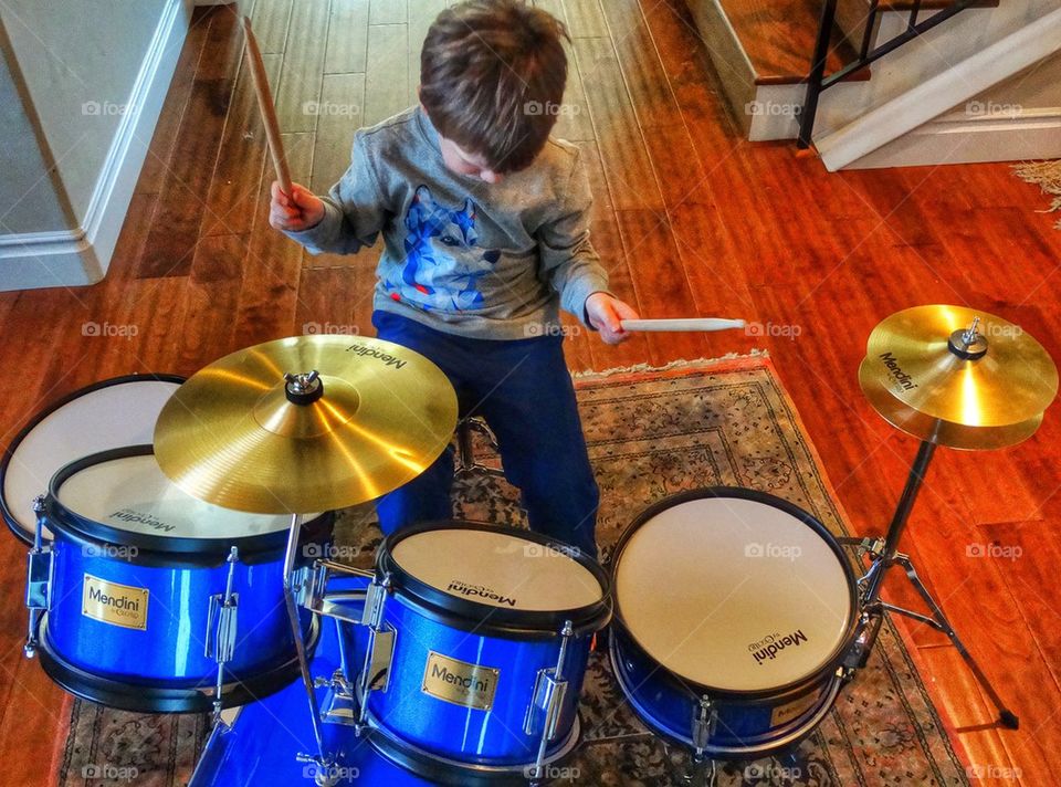 Young Boy Playing The Drums
