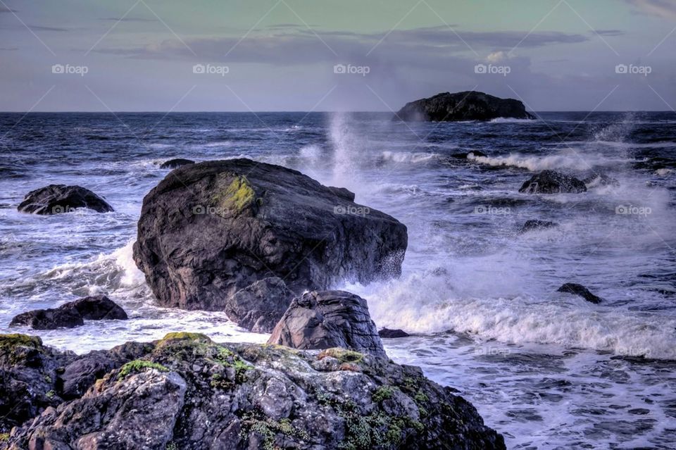 Waves splashing on rock at sea