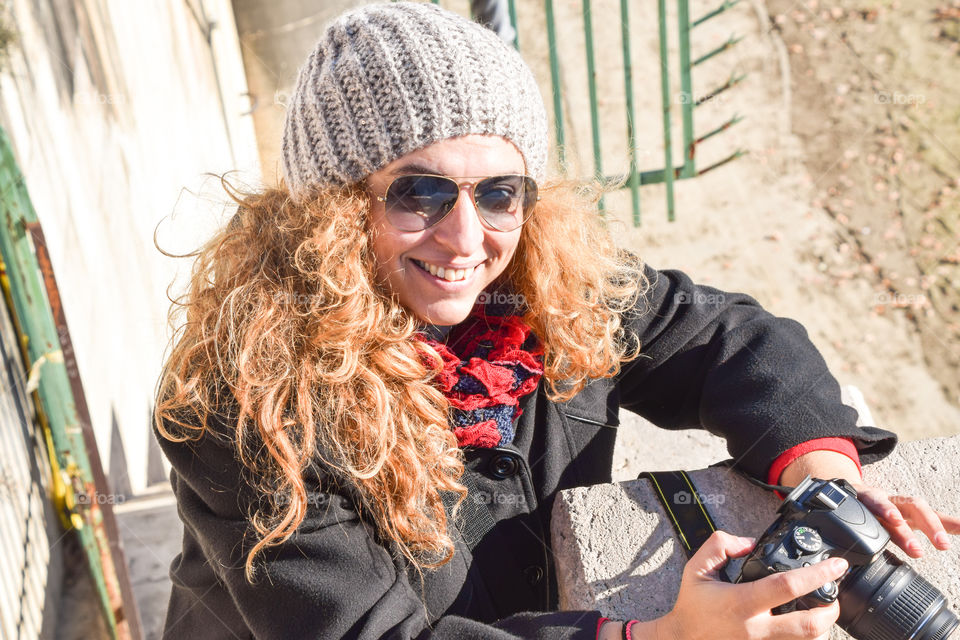 Beautiful Happy Smiling Blonde Young Woman Photographer Wearing Sunglasses And Cap
