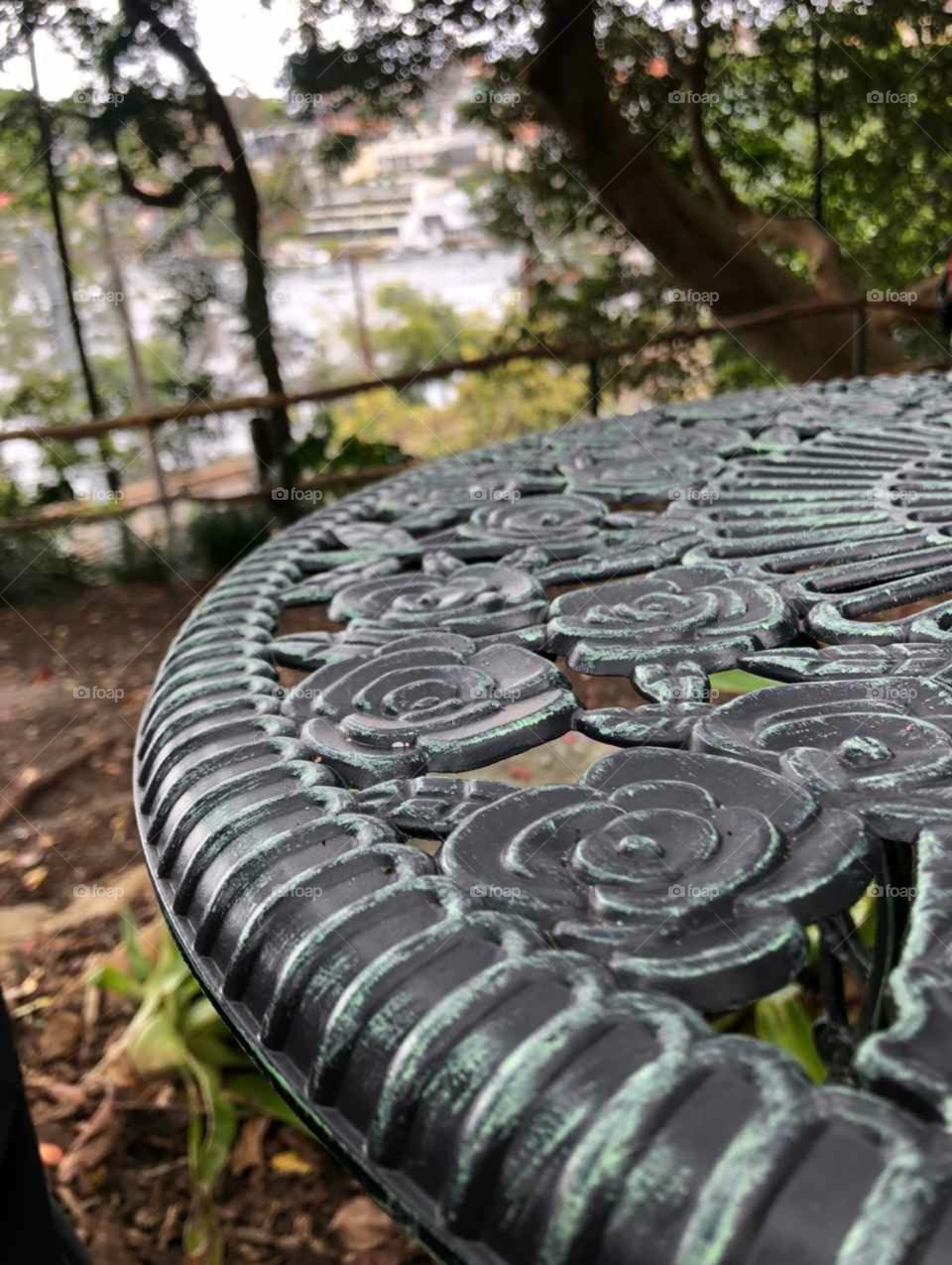 Round metal table with rose patterns in a park