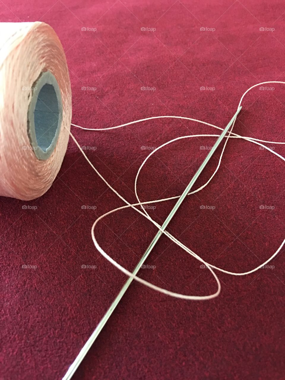 Side view upholstery thread roll on suede 