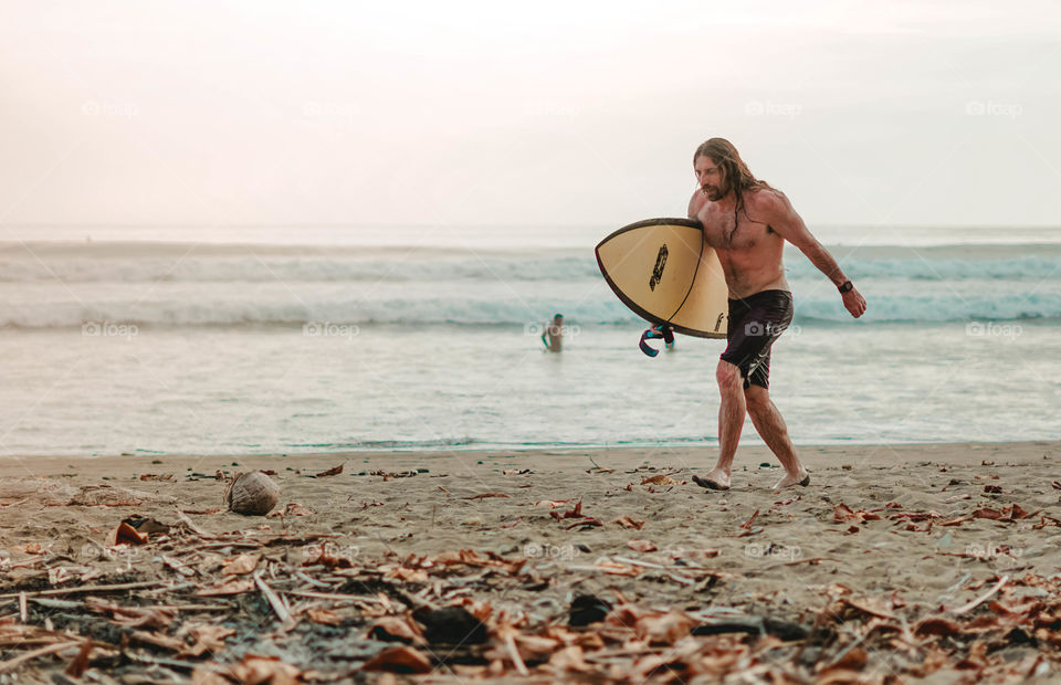 Man enjoying surfing on the beach in summer