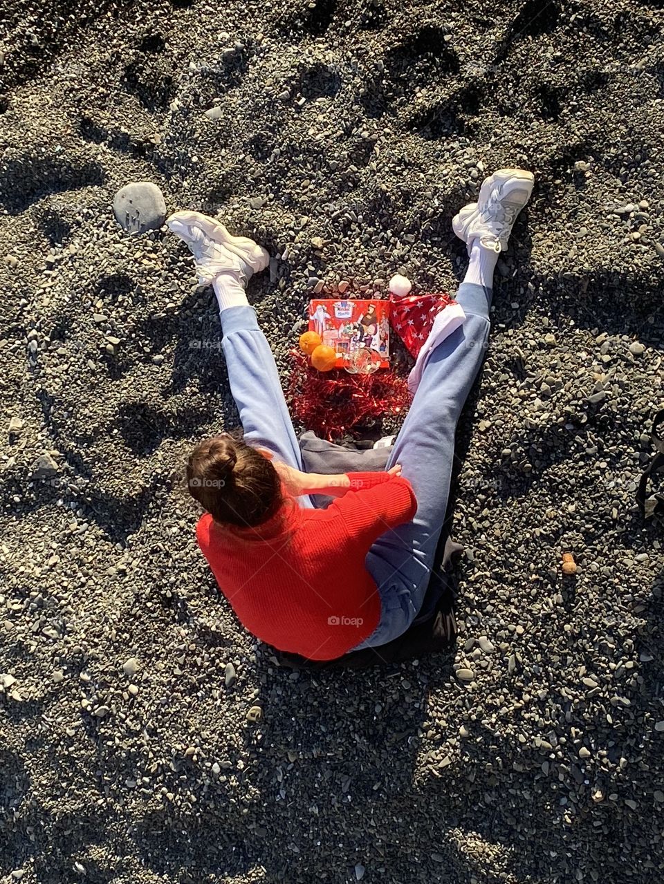Woman on a beach take a foodbrake with fruits and chocolate