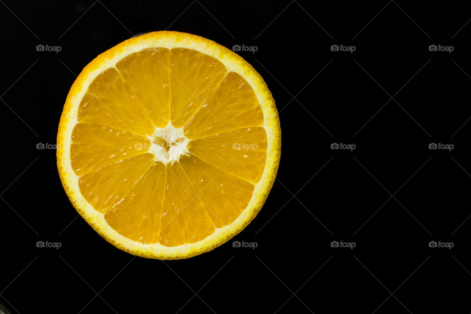 tangerine slice on a black background