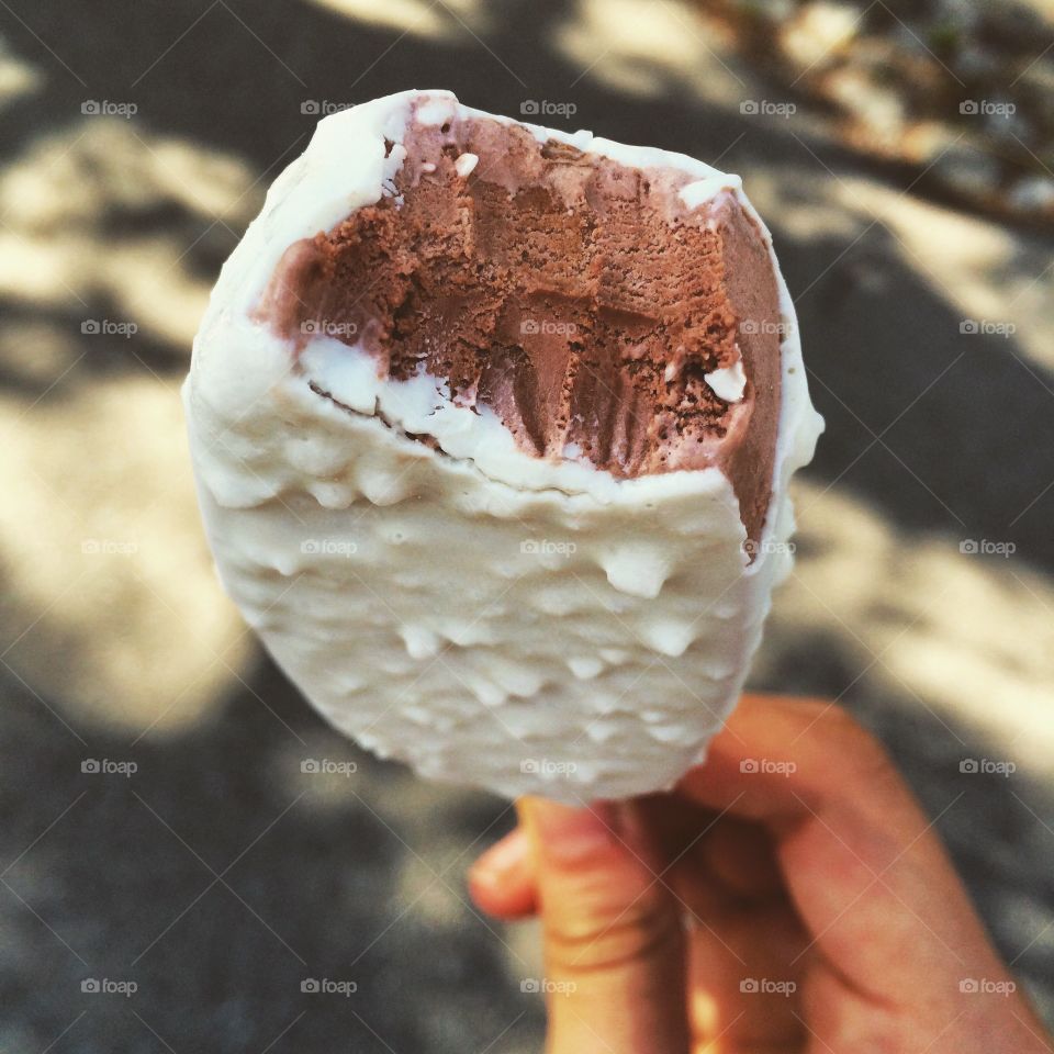 A person holding chocolate ice-cream