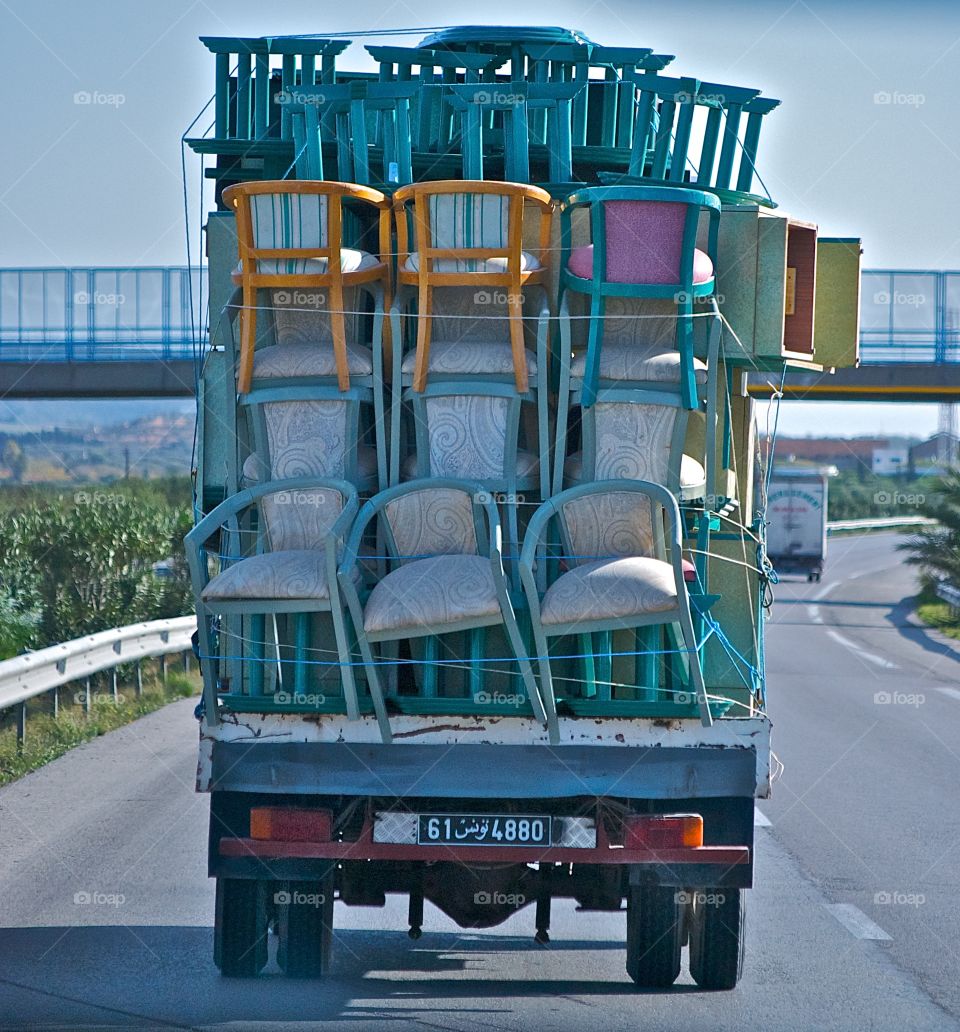 Truck precariously transporting furniture in Tunisia