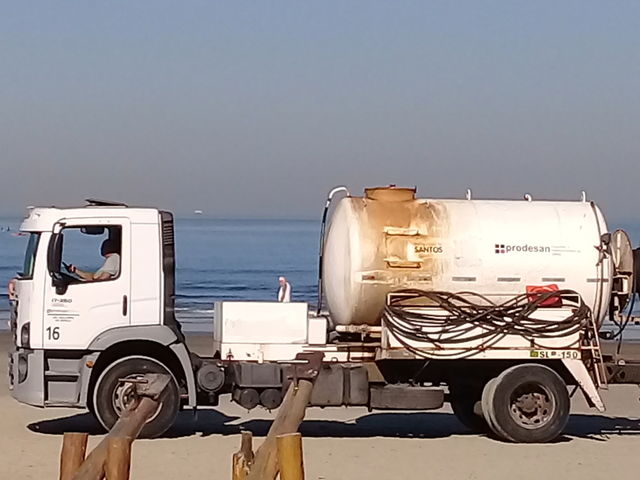 people in small businesses.  Cleaning truck on the beach