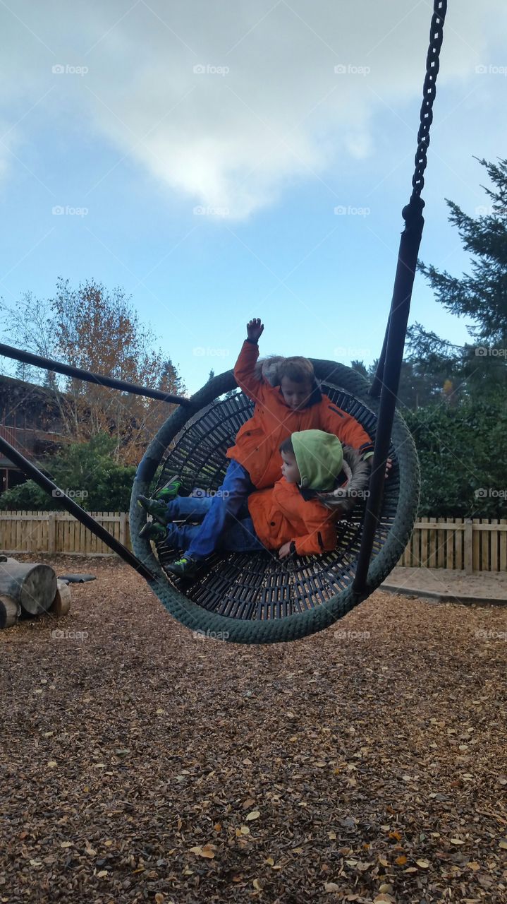 Two brother playing on hammock