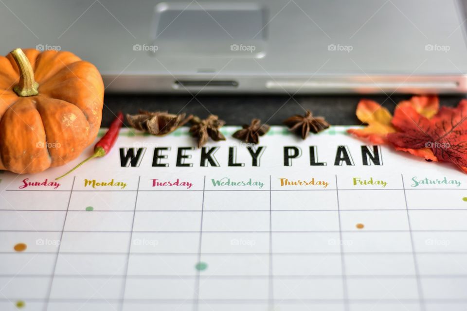 Desk laptop and a weekly planner 