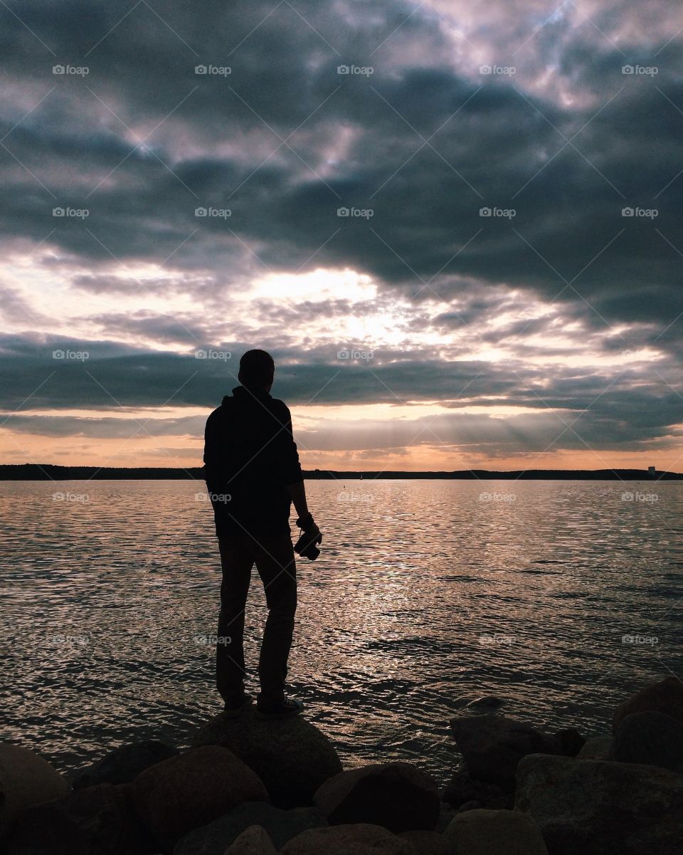 Photographer looking sunset on the beach 