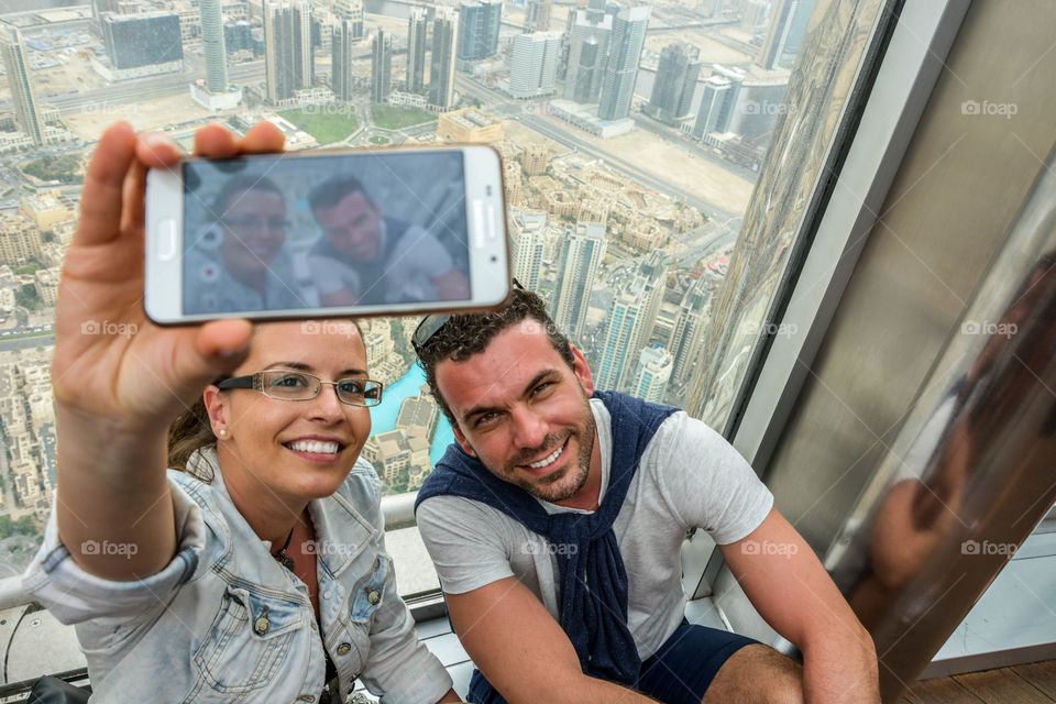 Happy couple taking selfie with mobile phone