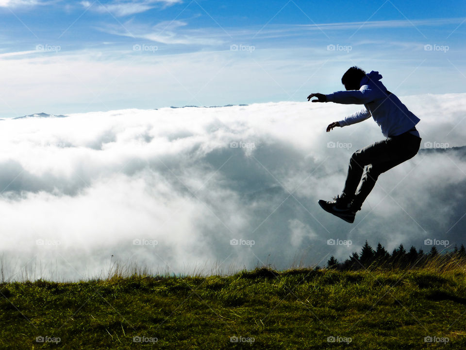 A man launched backwards over the clouds