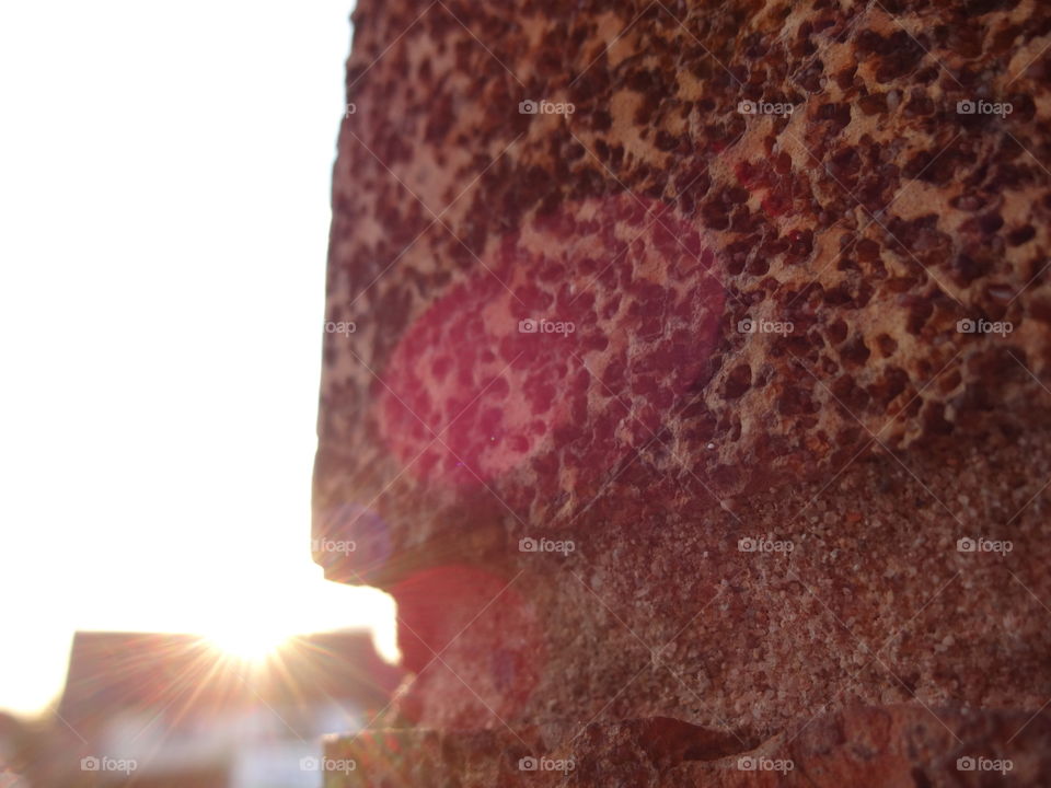 Illuminating sunrays behand the wall