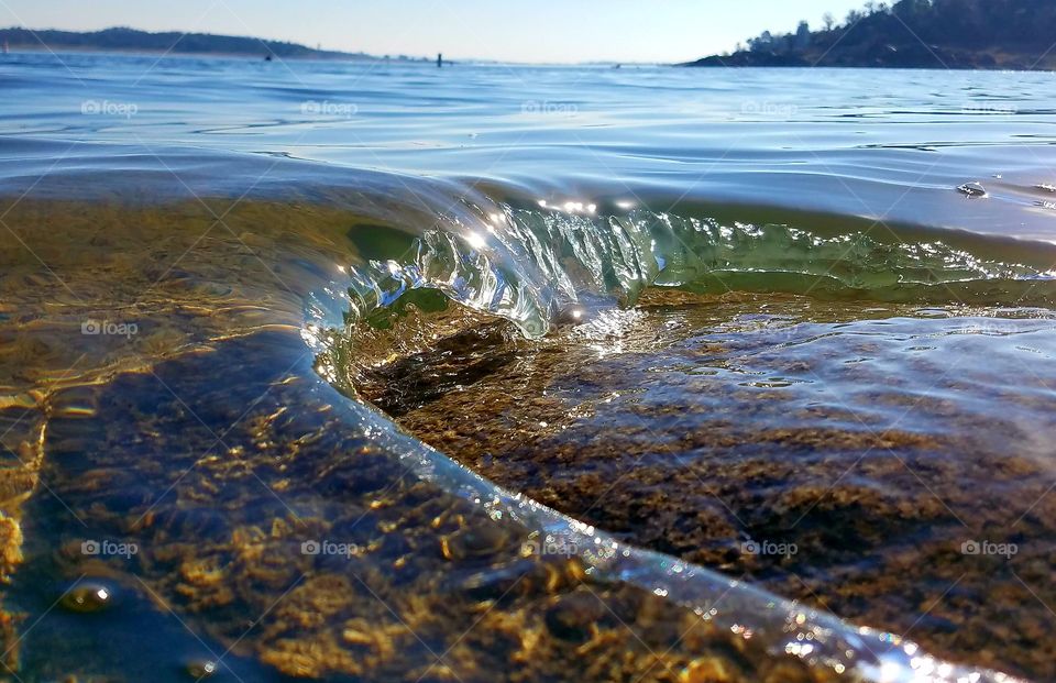 Clear wave breaking on a rock m lake