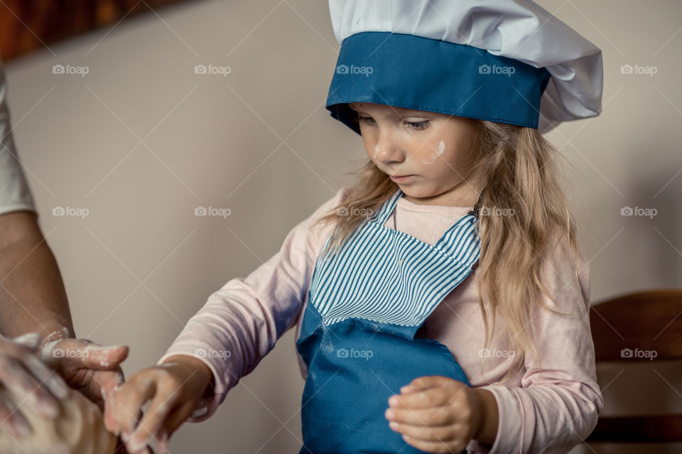 Little sisters cooking the biscuits 