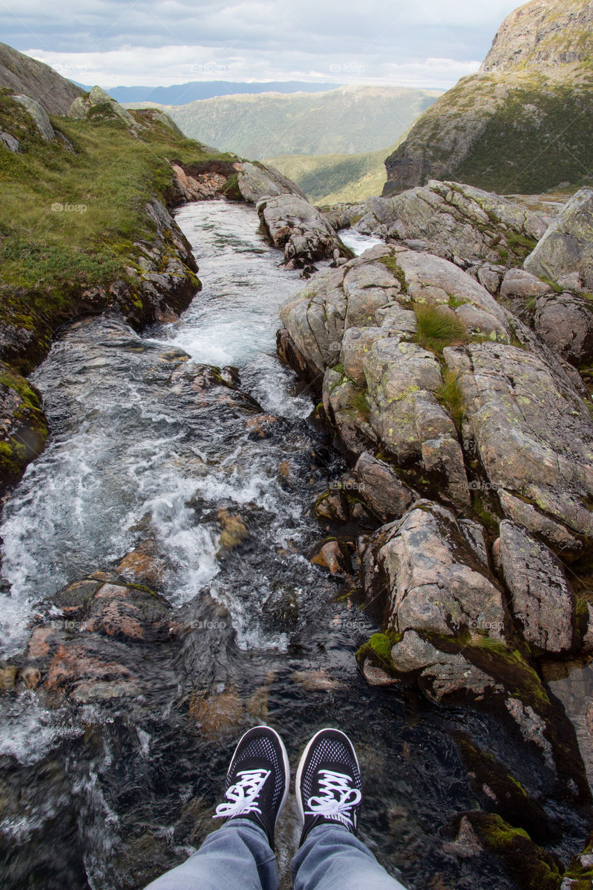 Lower section human foot and river