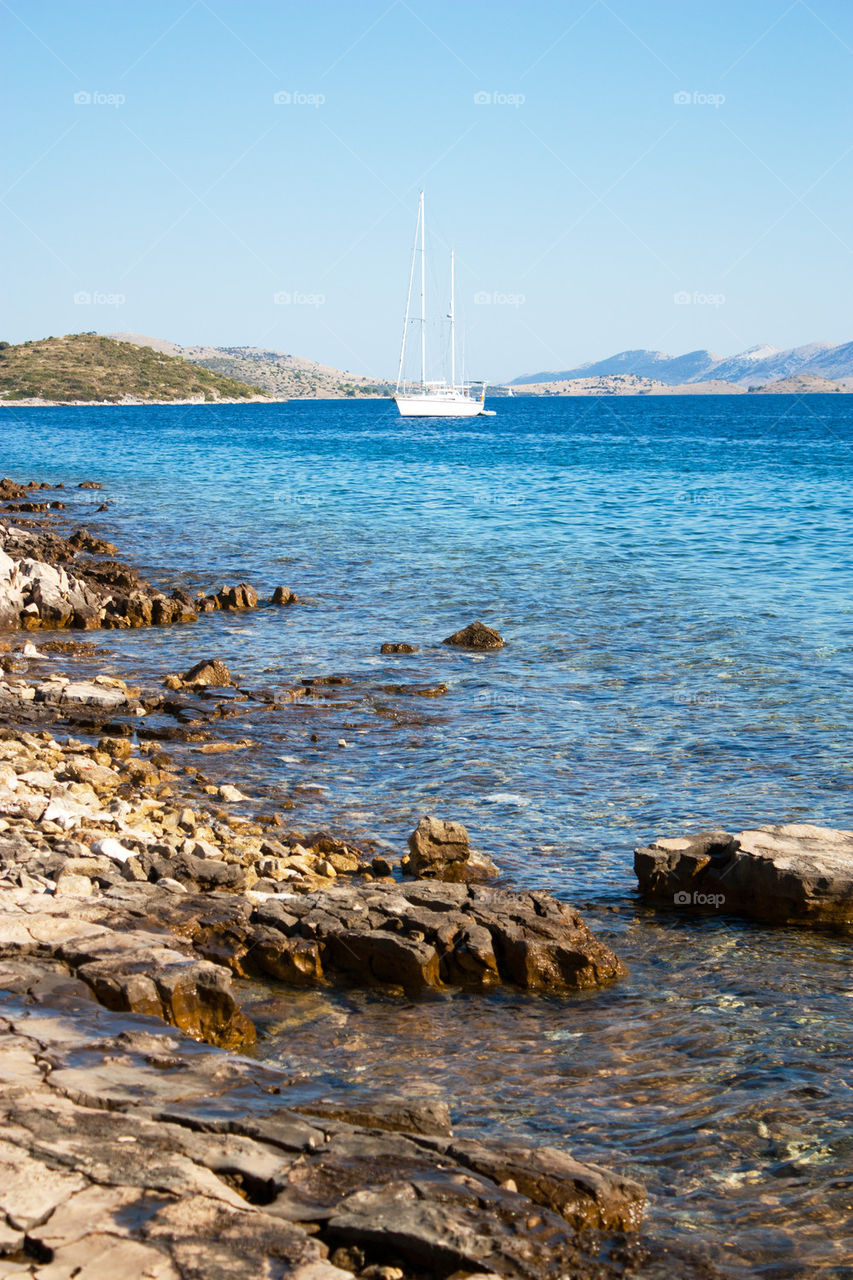 Sailboat in the sea against clear sky