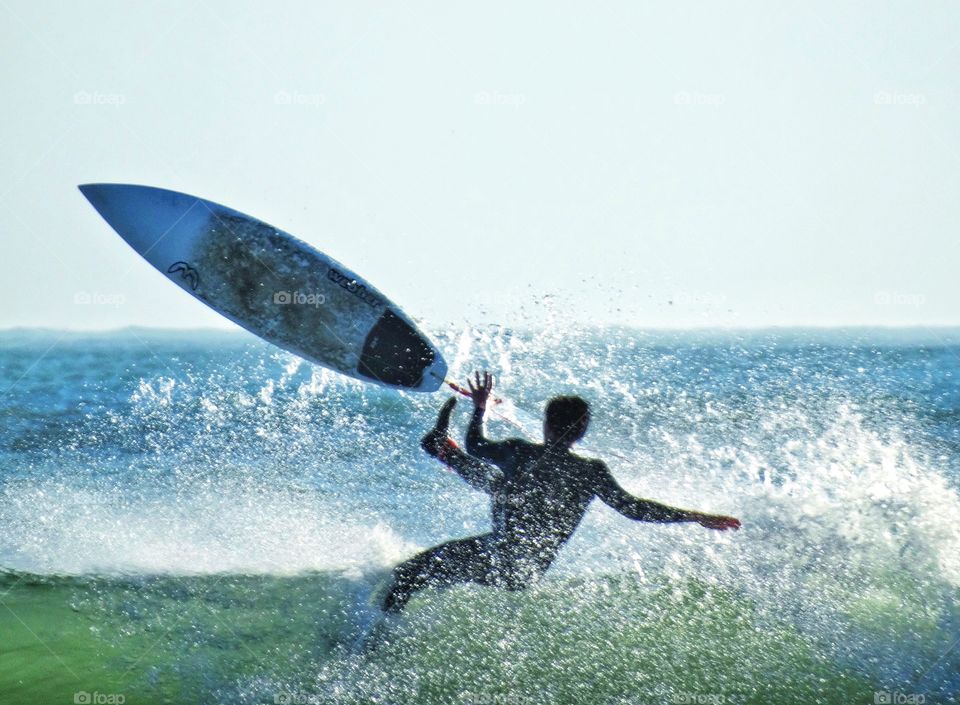 Surfer flying off his surfboard at Año Nuevo Beach in California