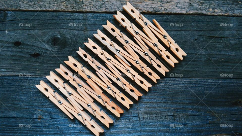 Wooden clothespins on a wooden base