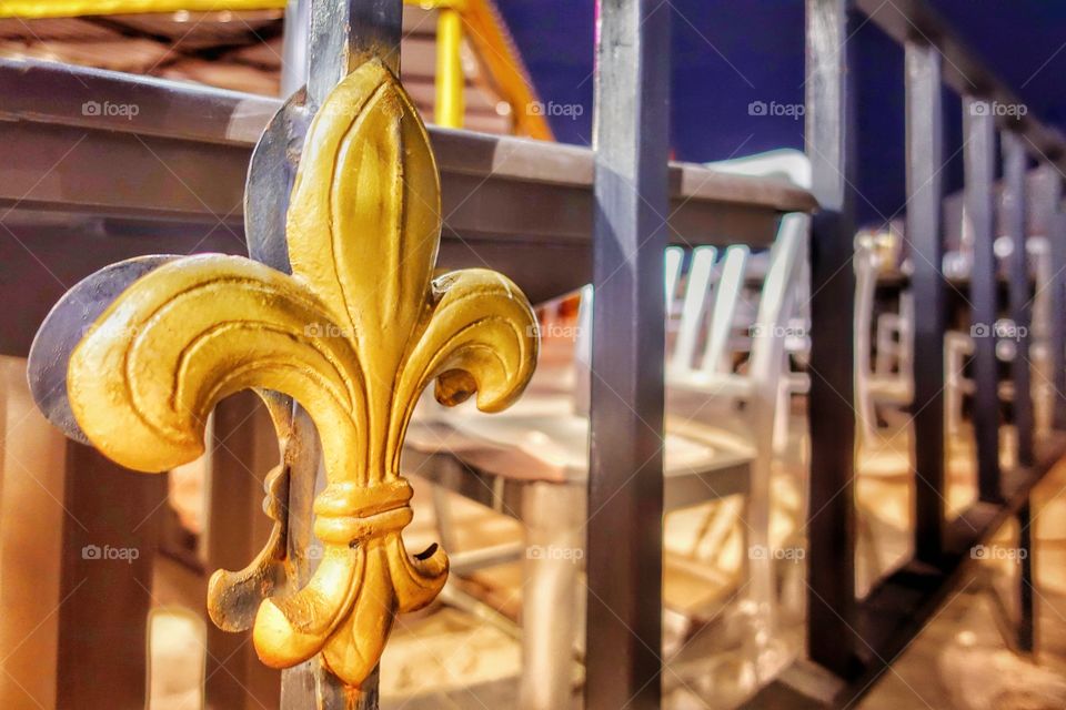 Fleur de lis insignia on a fence near the French Quarter. This is an official symbol of the State of Louisiana. New Orleans, USA.