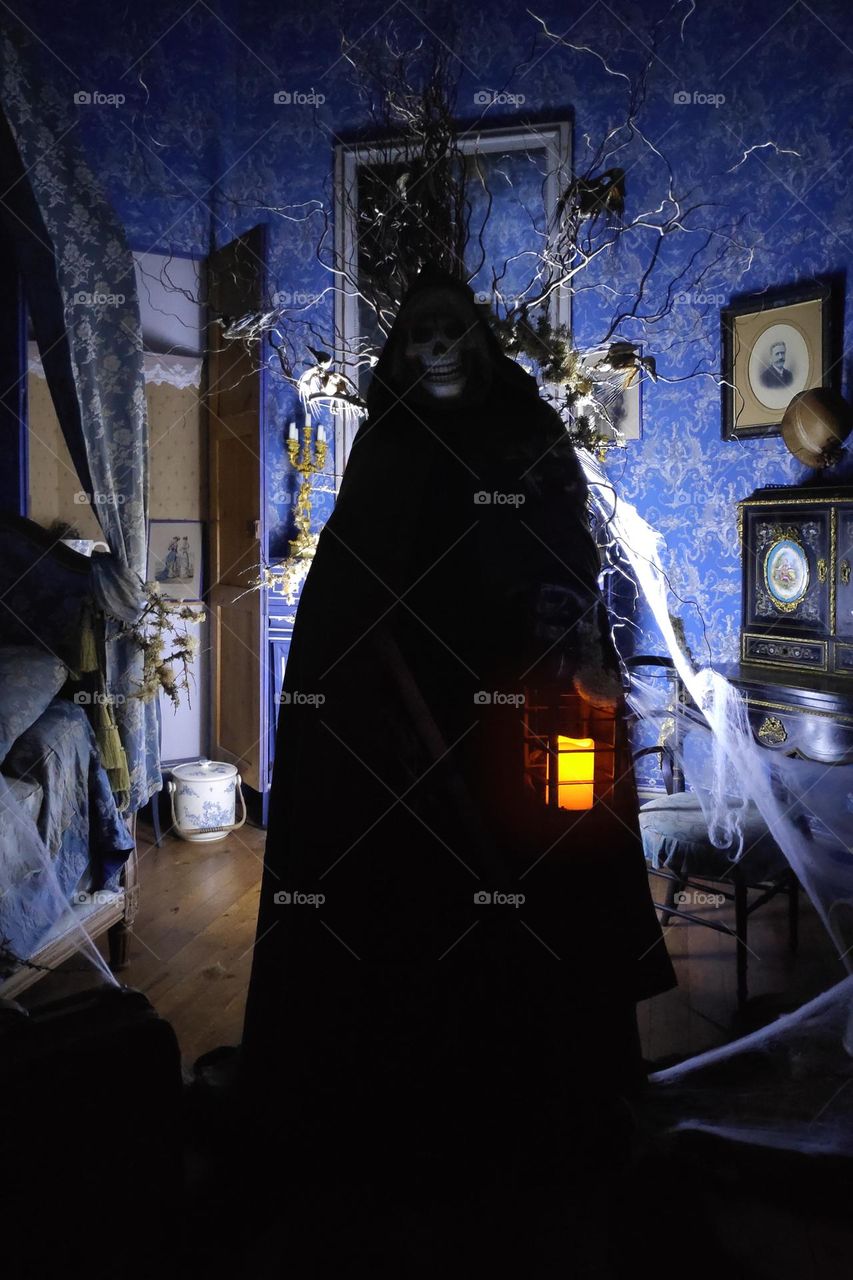 The Grim reaper haunting a castle on Halloween night