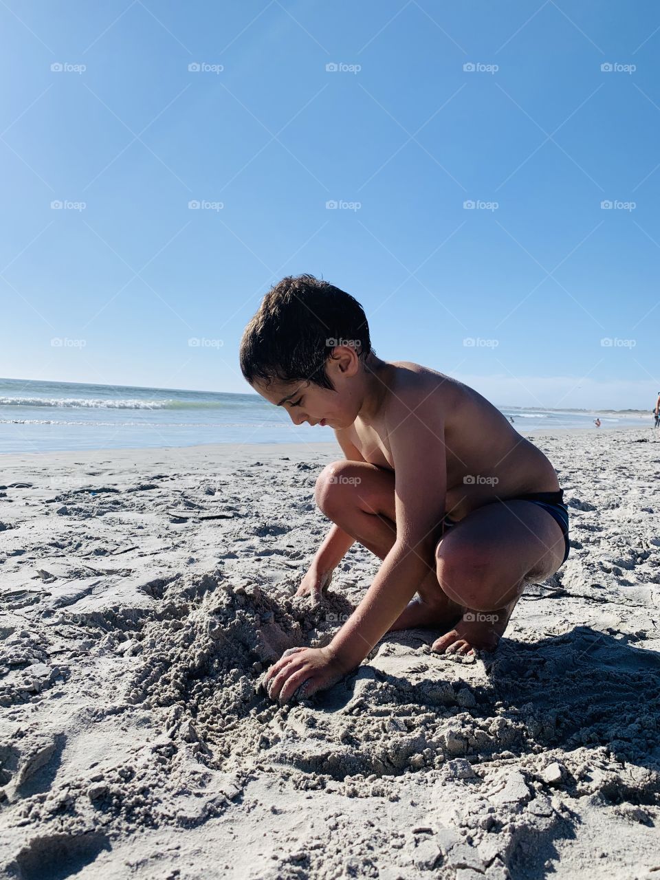 Boy playing on the beach 