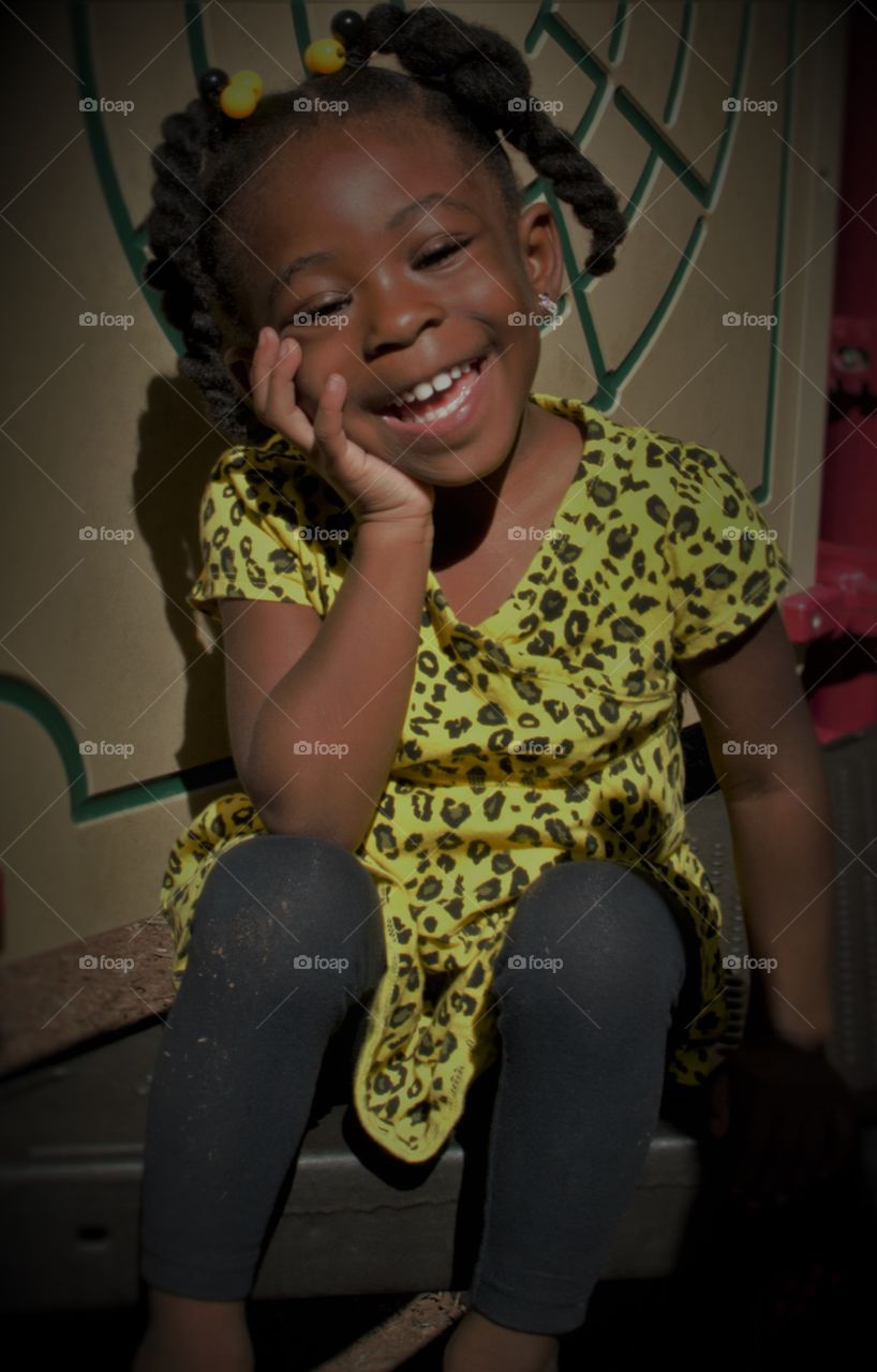 Portrait of African girl sitting and smiling