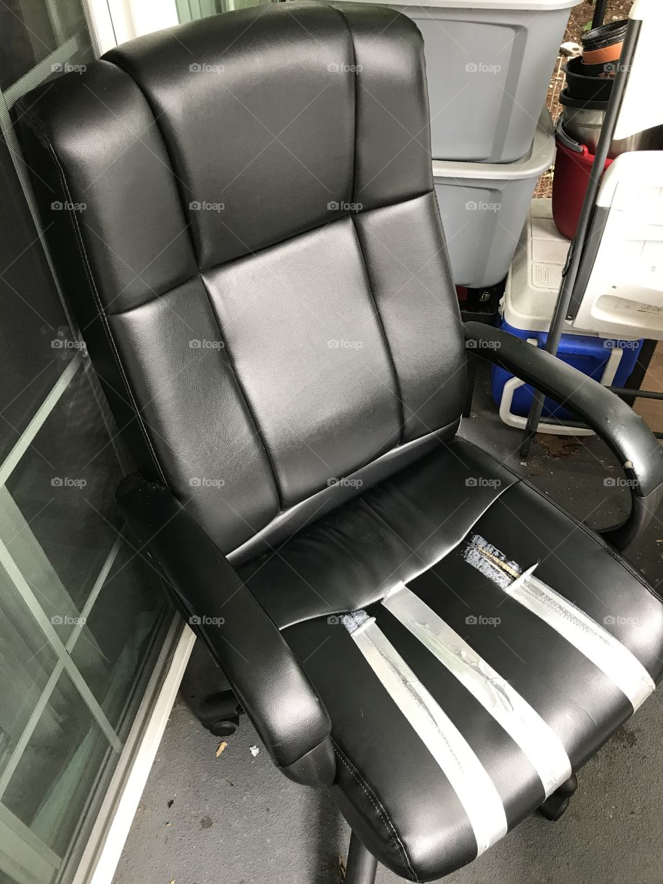 A perfectly workable office chair with some tears in the seat.