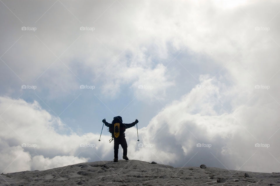 Man celebrates achieving the summit on Mount Eisenhower The White