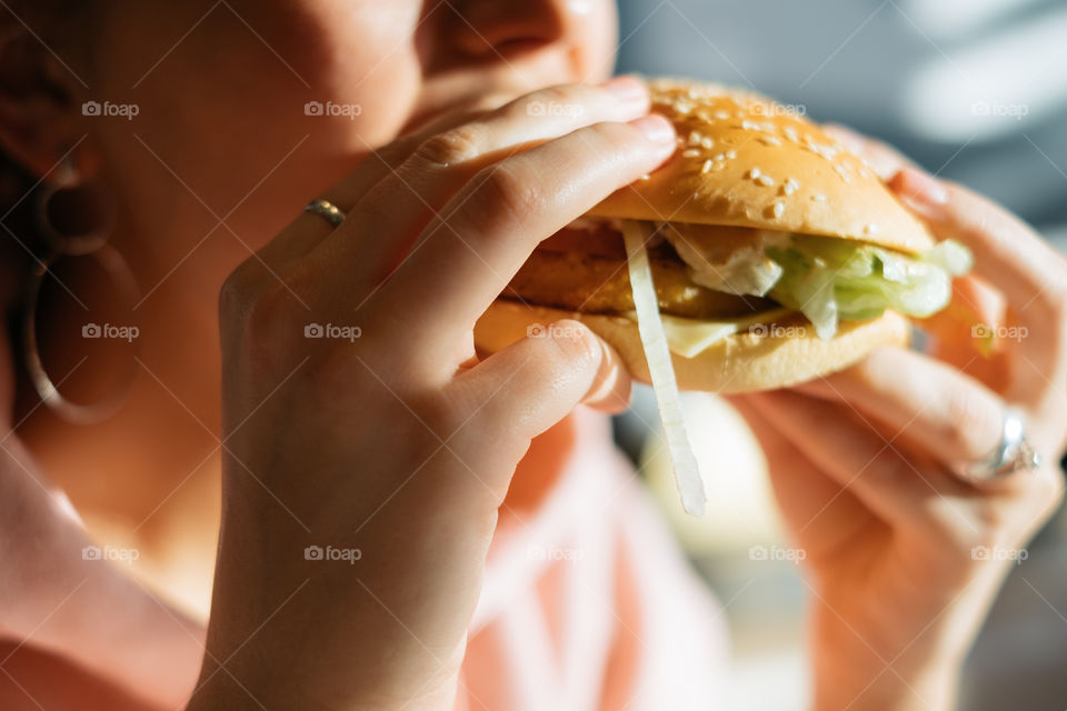 Woman eating fresh burger 