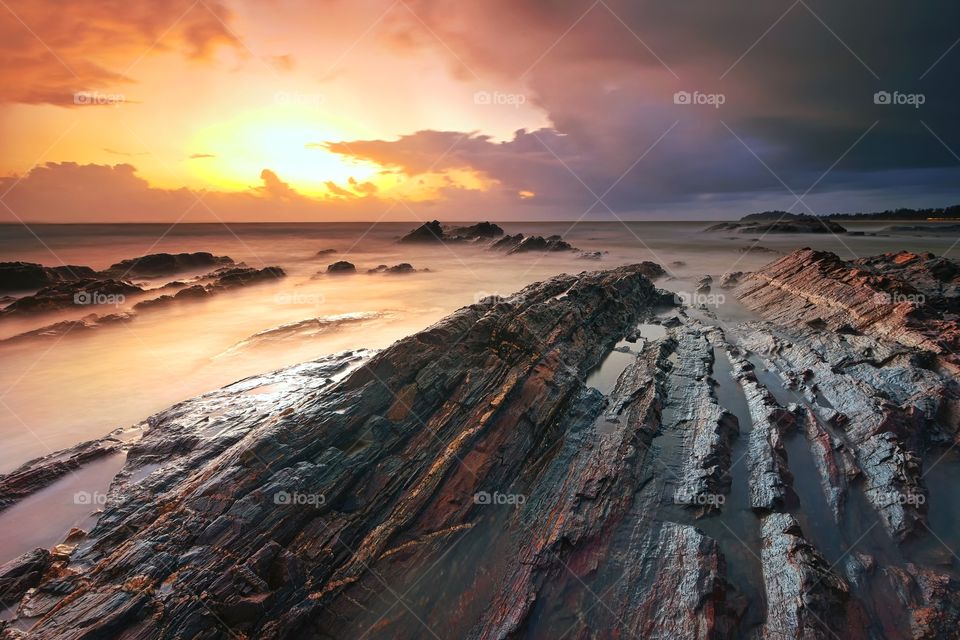 Sunrise over the rocky beach