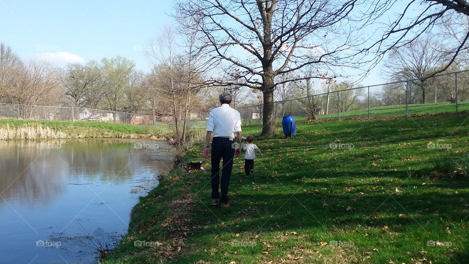 Family Outing. A family enjoying a warm spring day at a pond.