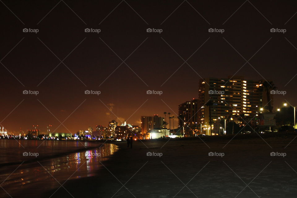 Long Beach city skyline view from the beach on a warm spring night