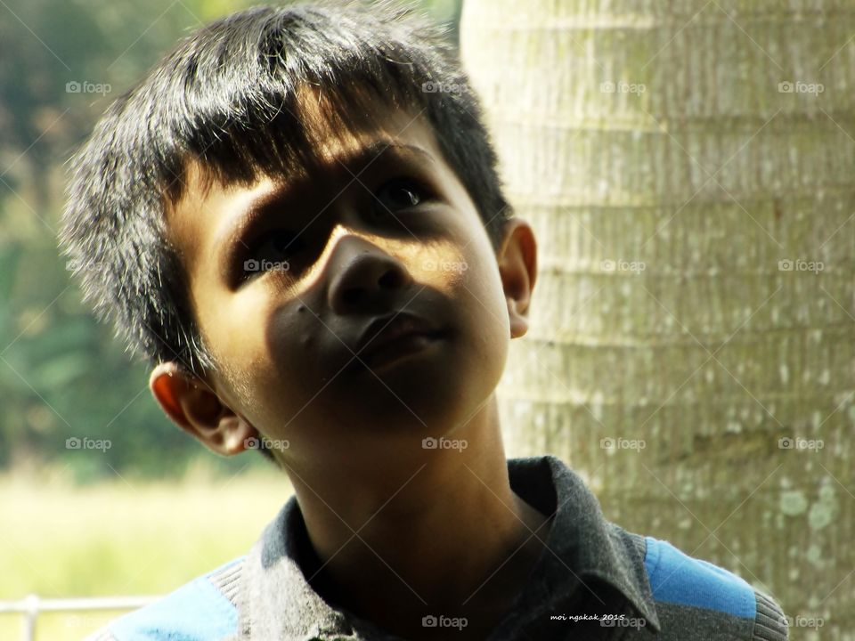 Close-up of thoughtful boy looking up