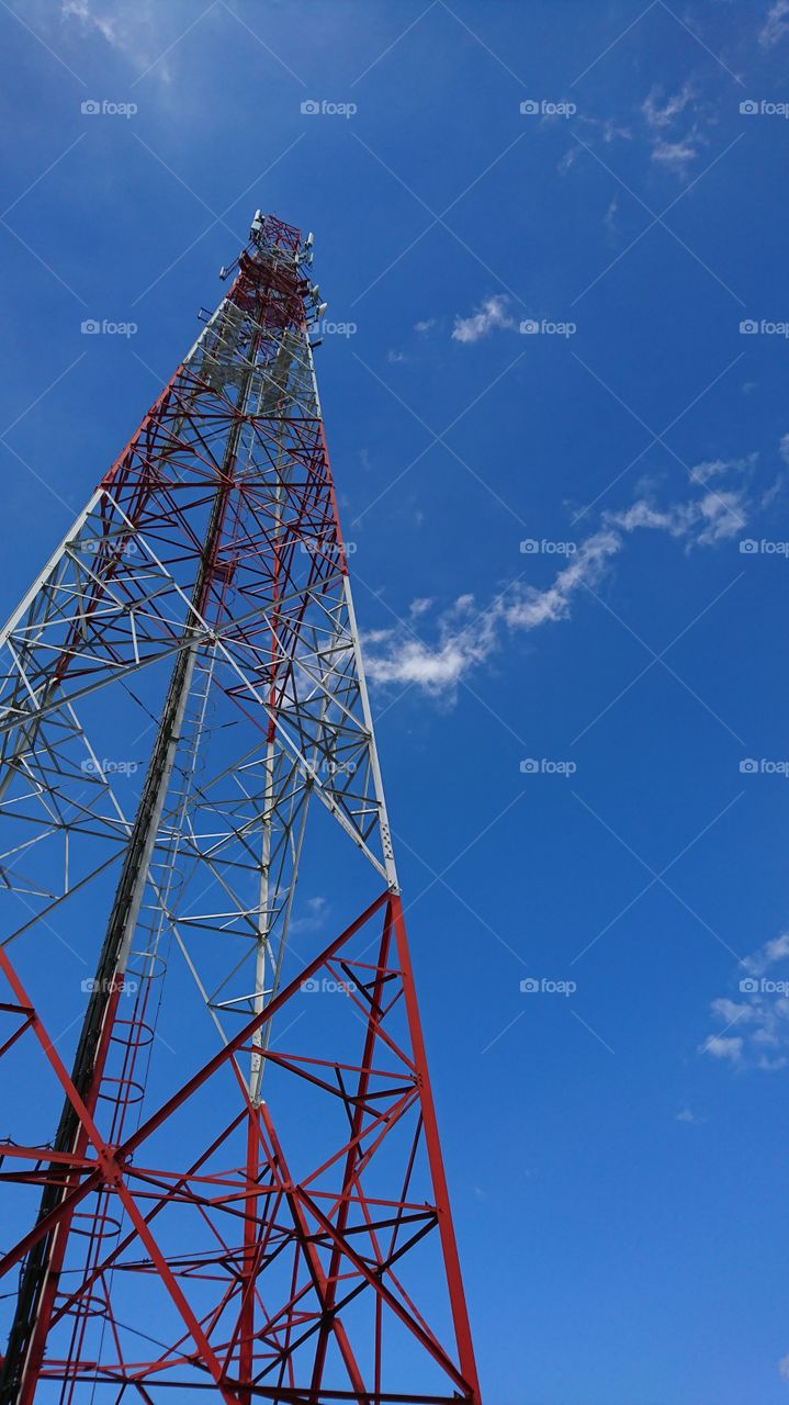 Mobile phone tower with bright blue sky background
