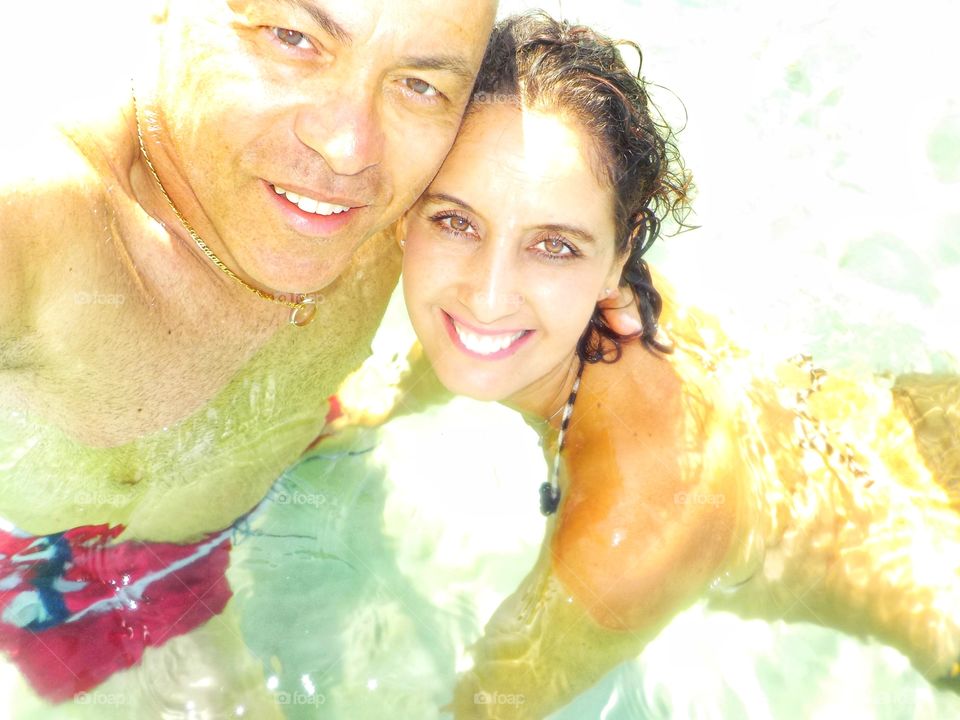 Selfie of a couple in the middle of the sea