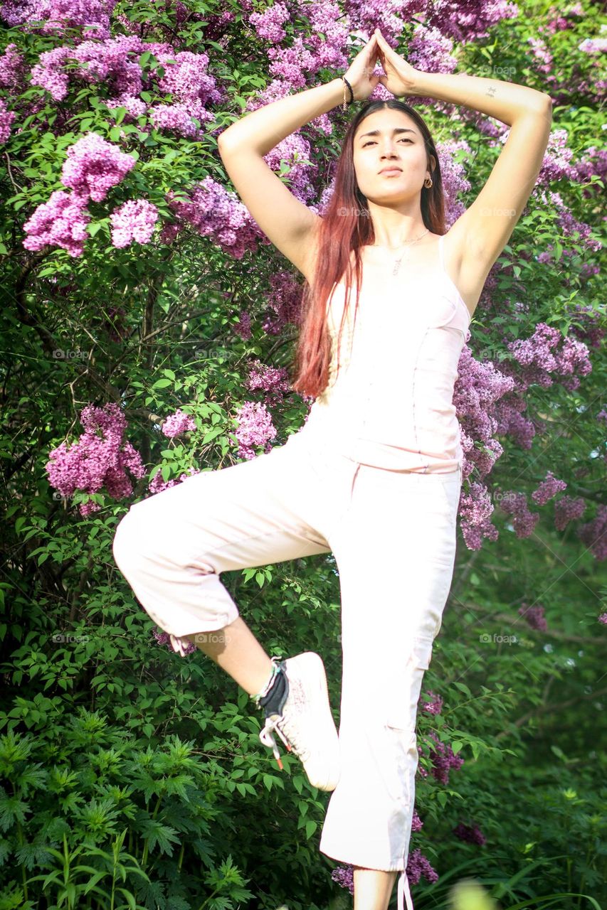 Young woman is doing yoga outdoors